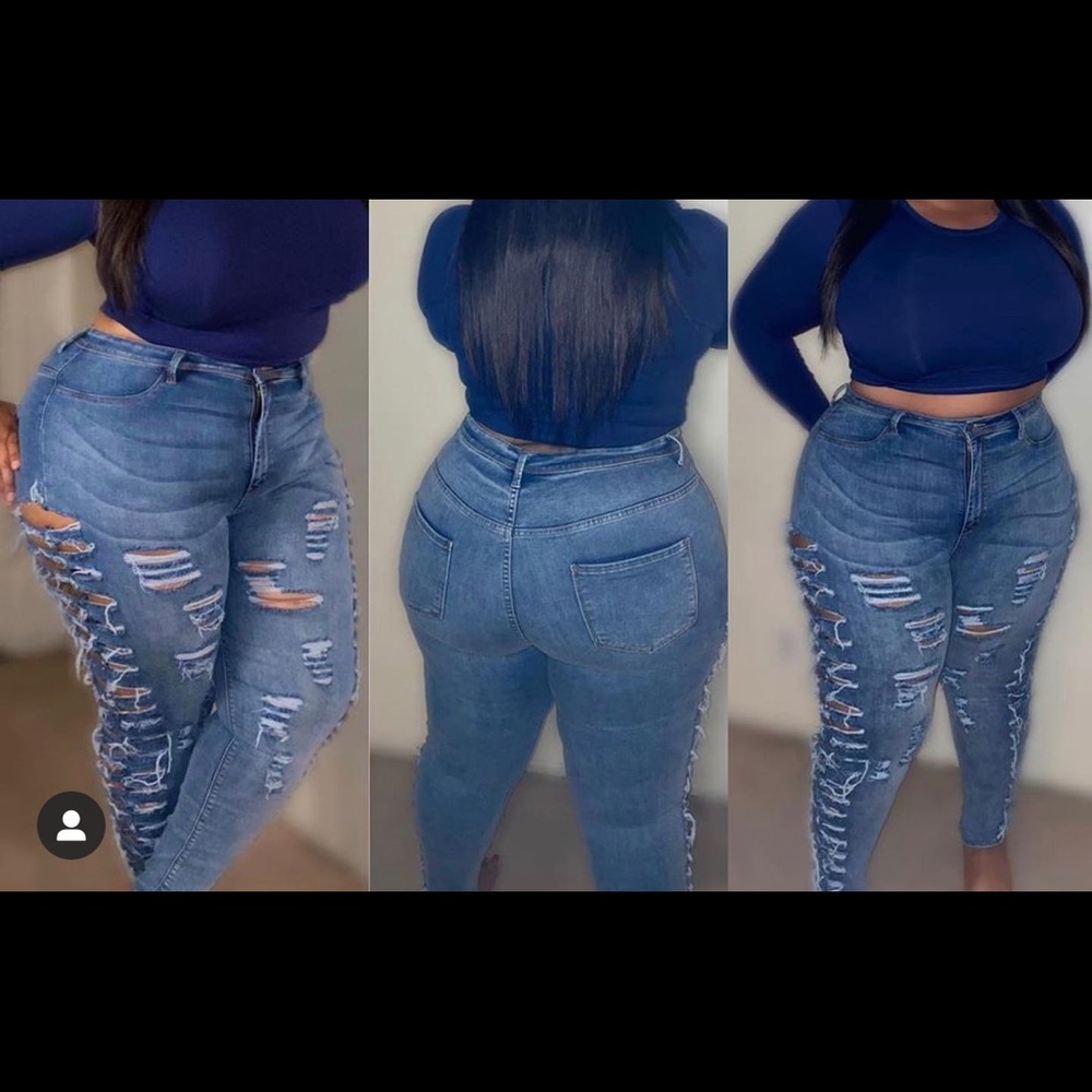 Distressed blue jeans with side rips